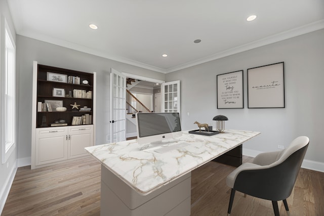 office area featuring light wood-type flooring and crown molding