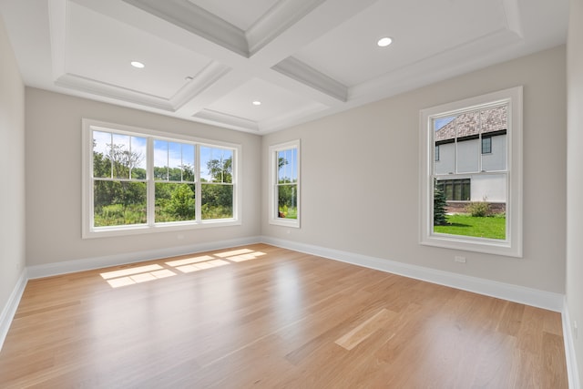 spare room featuring coffered ceiling, beamed ceiling, and light hardwood / wood-style floors