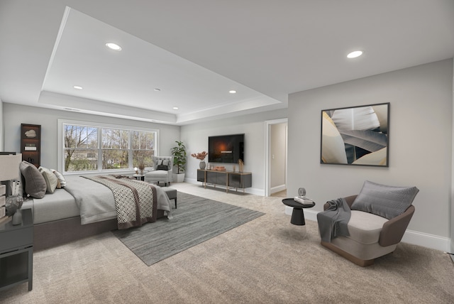 carpeted bedroom featuring a raised ceiling