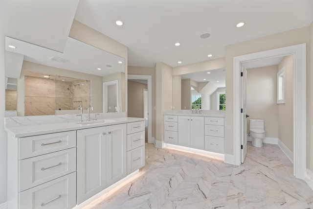 bathroom featuring tiled shower, vanity, and toilet