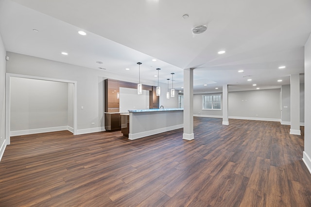 unfurnished living room featuring dark hardwood / wood-style floors