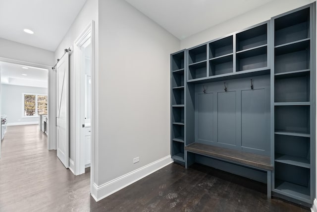 mudroom with baseboards, recessed lighting, a barn door, and dark wood finished floors