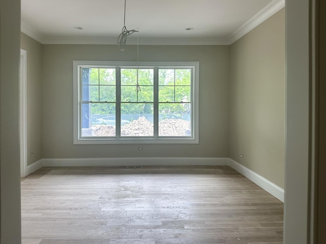 213 Northampton Ln, Lincolnshire, IL 60069 - spare room featuring plenty of natural light, baseboards, wood finished floors, and ornamental molding