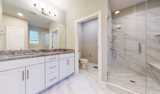 bathroom featuring a shower with door, tile flooring, double vanity, and toilet