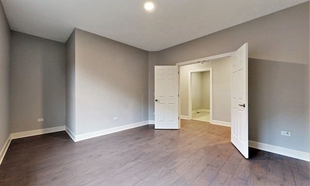 unfurnished room featuring hardwood / wood-style flooring