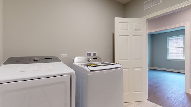 washroom featuring washer and dryer, washer hookup, and light wood-type flooring