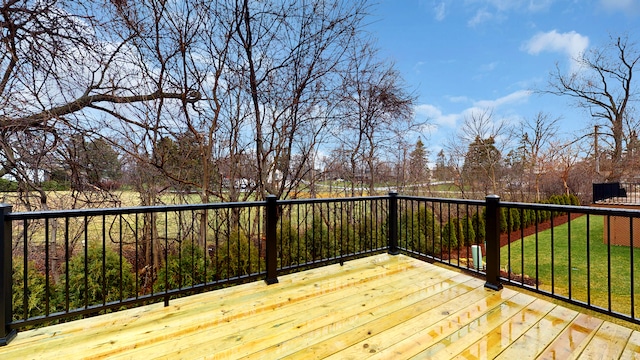 wooden terrace featuring a lawn