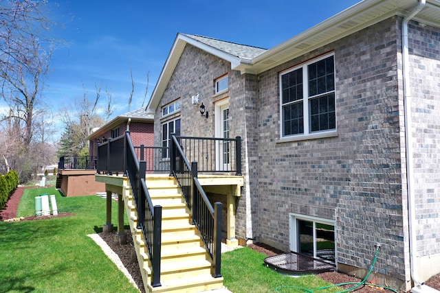 back of property with a lawn and a wooden deck