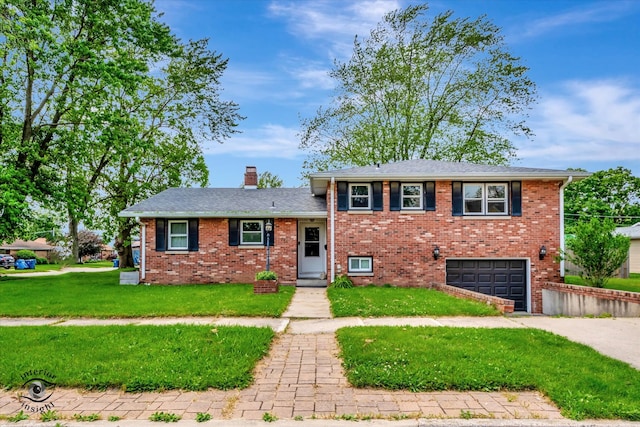 split level home with a garage and a front lawn