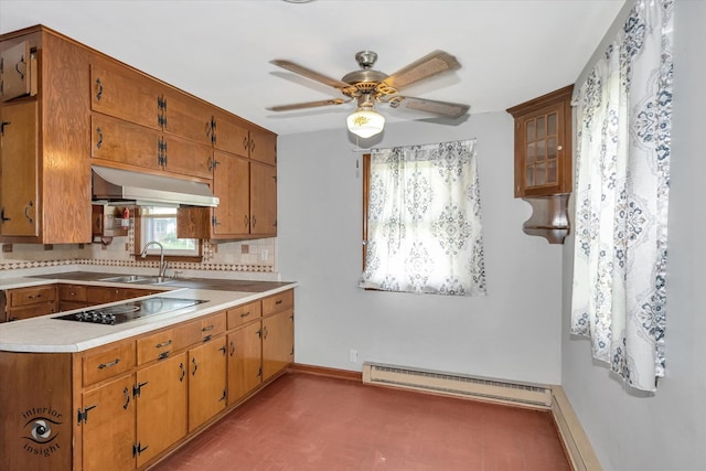 kitchen with baseboard heating, ceiling fan, tasteful backsplash, black electric cooktop, and sink