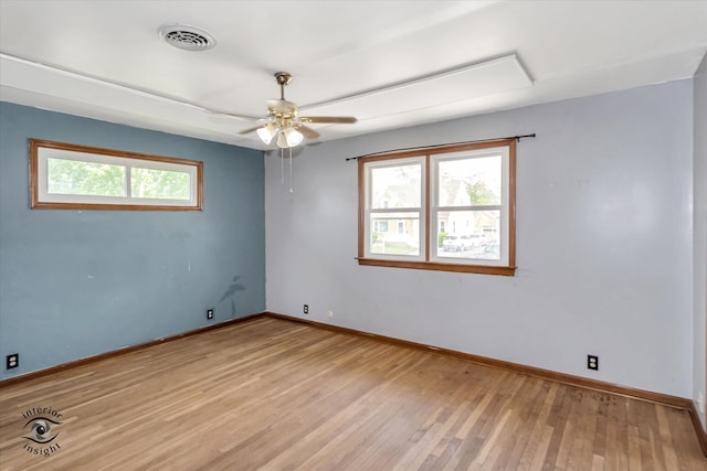 spare room featuring light wood-type flooring and ceiling fan