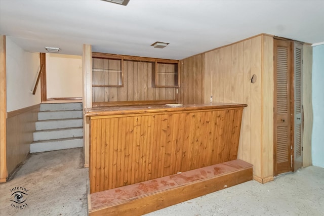 interior space with bar area and wooden walls