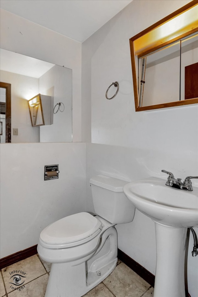 bathroom with tile flooring and toilet