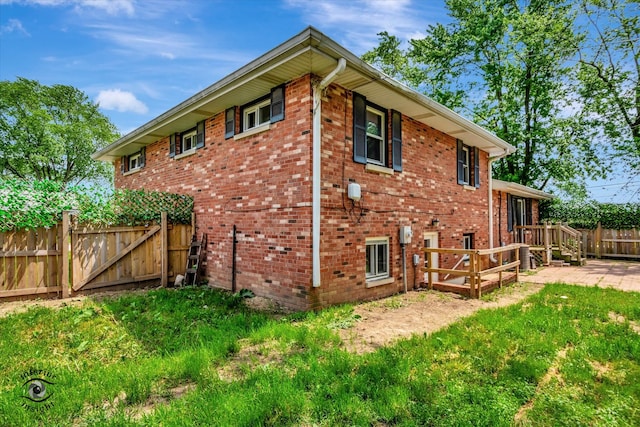 rear view of property featuring a yard