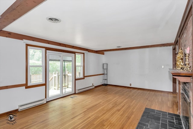 unfurnished living room with light hardwood / wood-style floors and baseboard heating