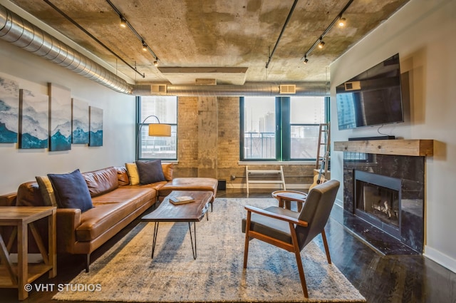 living room featuring a fireplace, plenty of natural light, and dark hardwood / wood-style floors