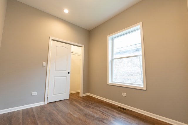 empty room featuring dark hardwood / wood-style floors and plenty of natural light