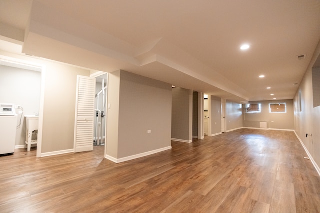 basement with hardwood / wood-style flooring and washer / dryer