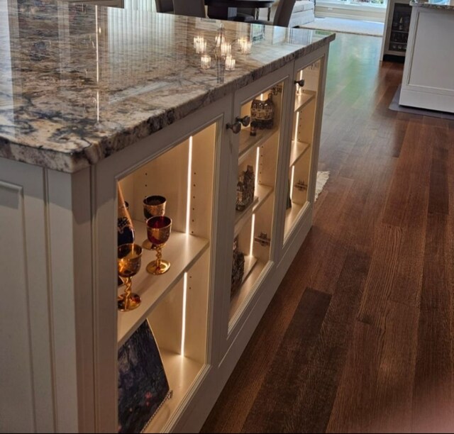 wine cellar with dark hardwood / wood-style floors and wine cooler