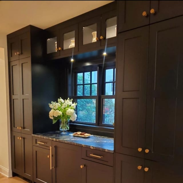 bar featuring stone countertops