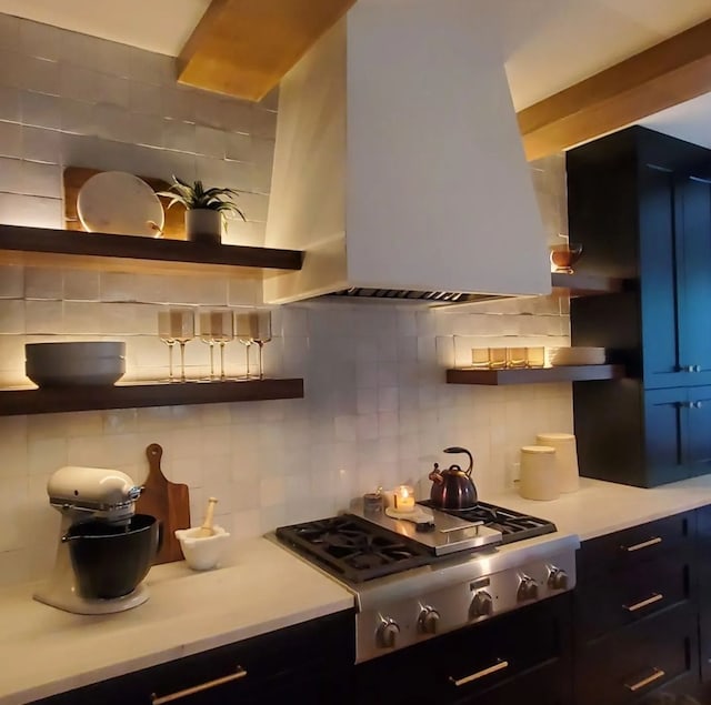 kitchen with island exhaust hood, tasteful backsplash, and stainless steel gas stovetop