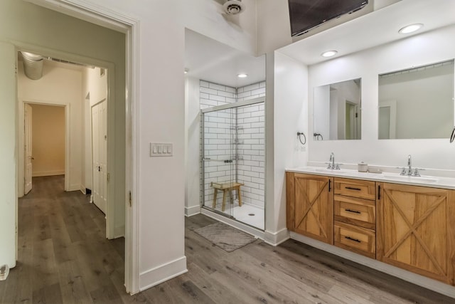 bathroom featuring vanity, wood-type flooring, and an enclosed shower