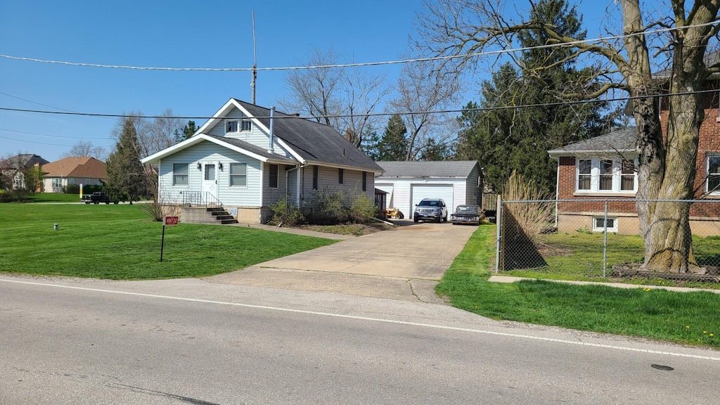 view of front facade with an outdoor structure, a garage, and a front lawn