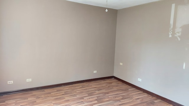 empty room with wood-type flooring