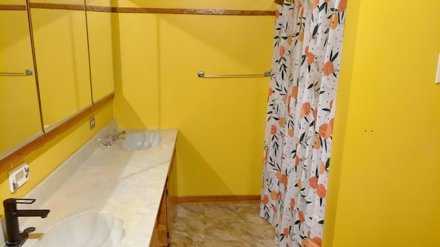 bathroom featuring tile floors and vanity with extensive cabinet space