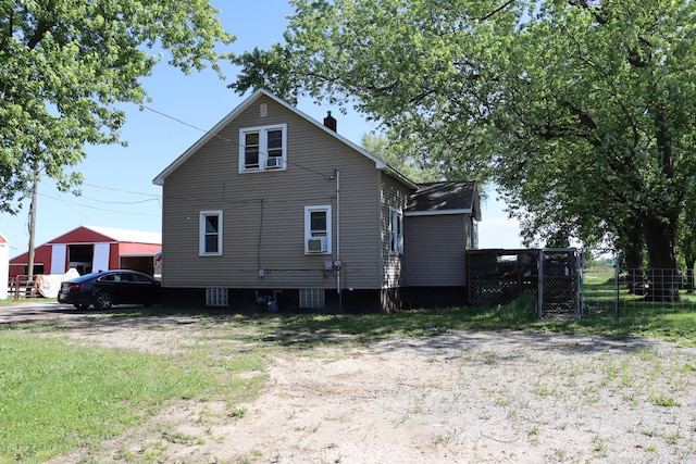 view of property exterior with cooling unit and fence