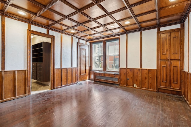 unfurnished room featuring beam ceiling, wood-type flooring, coffered ceiling, ornamental molding, and radiator