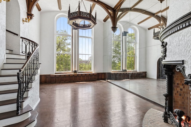 living room featuring high vaulted ceiling, wood-type flooring, and beam ceiling