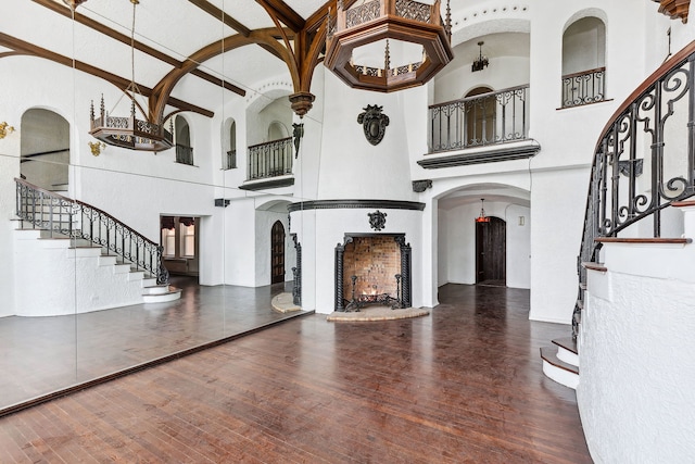 unfurnished living room with dark hardwood / wood-style floors and high vaulted ceiling