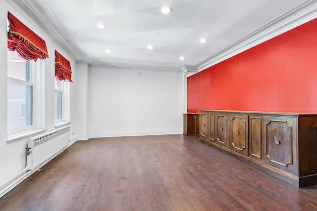 unfurnished room with dark hardwood / wood-style floors, ornamental molding, and radiator