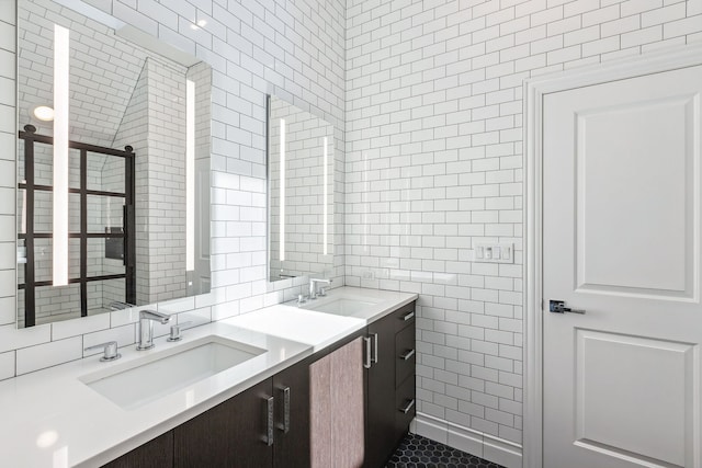 bathroom with tile flooring, tile walls, and double vanity