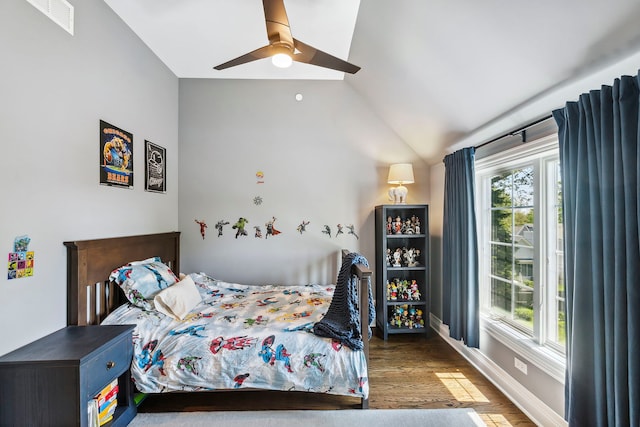 bedroom with lofted ceiling, hardwood / wood-style flooring, ceiling fan, and multiple windows