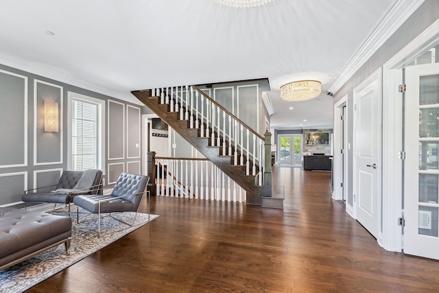 foyer with crown molding and dark hardwood / wood-style flooring