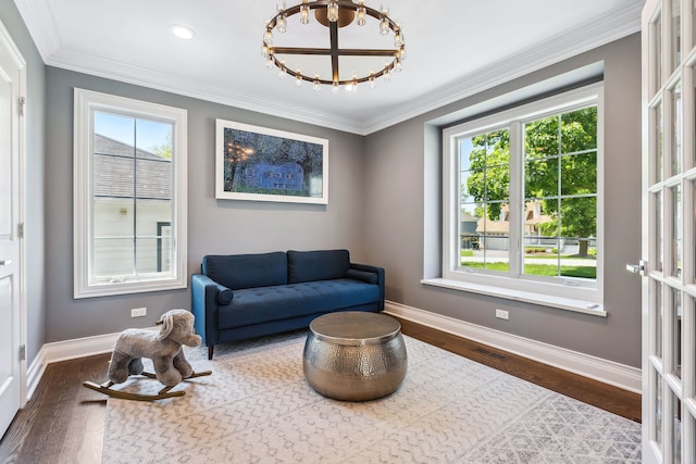 sitting room featuring a wealth of natural light, hardwood / wood-style floors, and crown molding