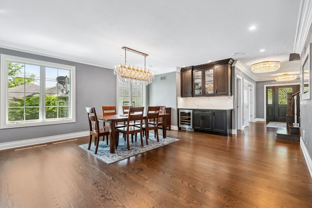 dining space with beverage cooler, crown molding, and dark wood-type flooring