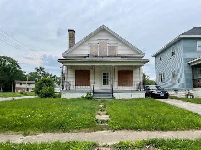 bungalow-style house with a front lawn and a porch