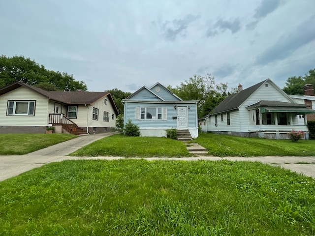 bungalow-style home featuring a front lawn