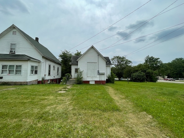 rear view of house featuring a yard