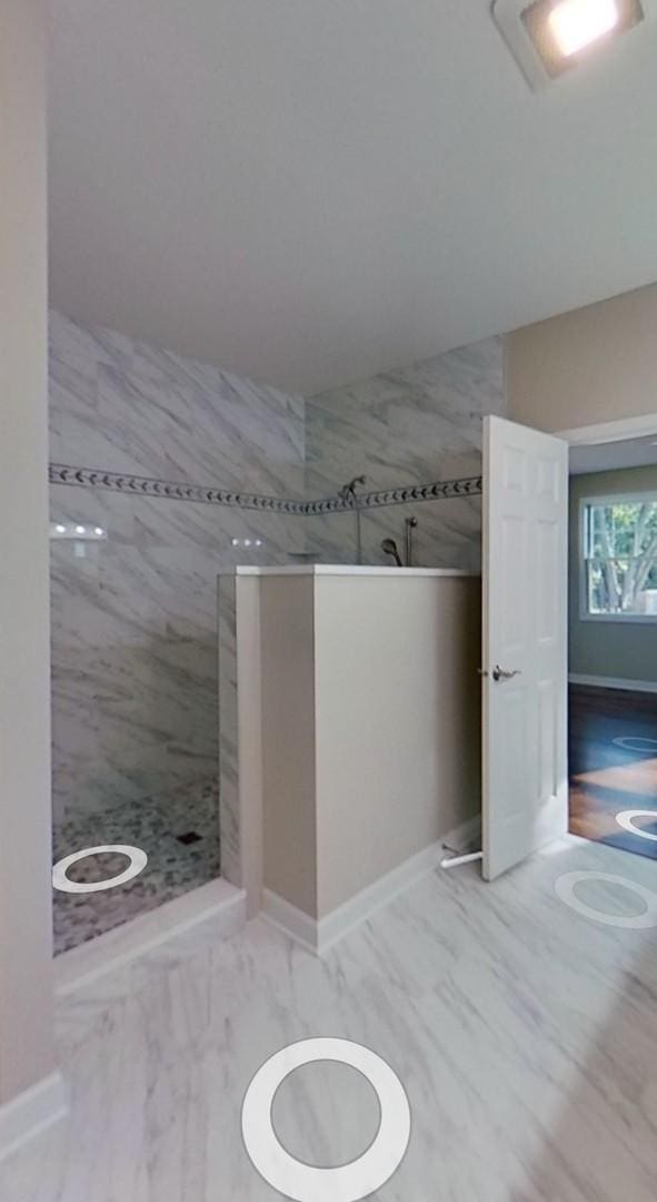 bathroom with tiled shower