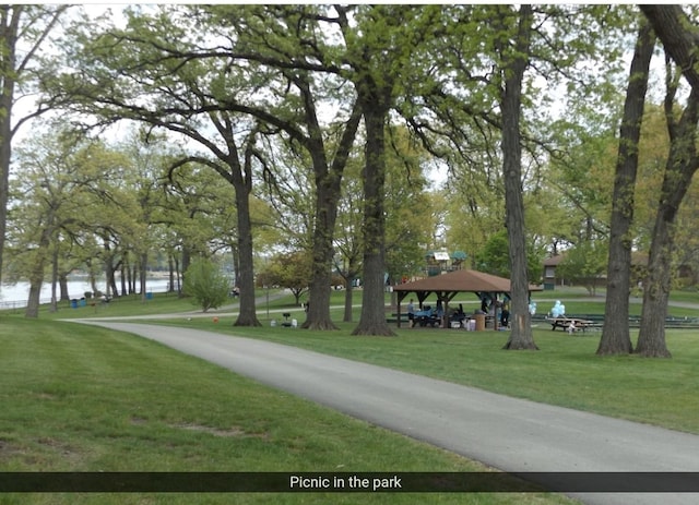 view of home's community featuring a gazebo, a water view, and a lawn