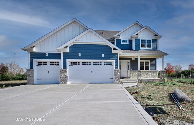 craftsman inspired home featuring a garage and a porch