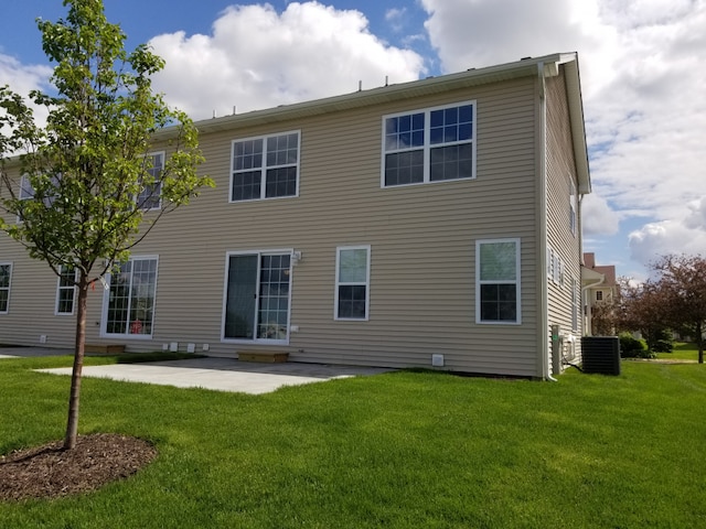 back of house featuring a patio, central AC, and a lawn