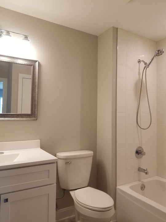 full bathroom featuring tiled shower / bath, toilet, and vanity