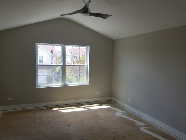 empty room with ceiling fan and vaulted ceiling