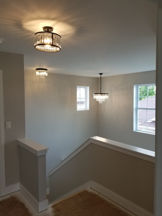 unfurnished room featuring a healthy amount of sunlight and a chandelier