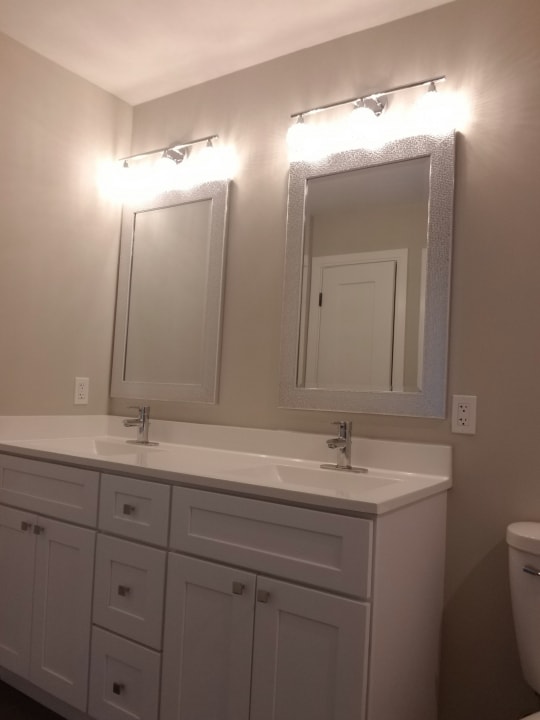 bathroom with double sink vanity and toilet